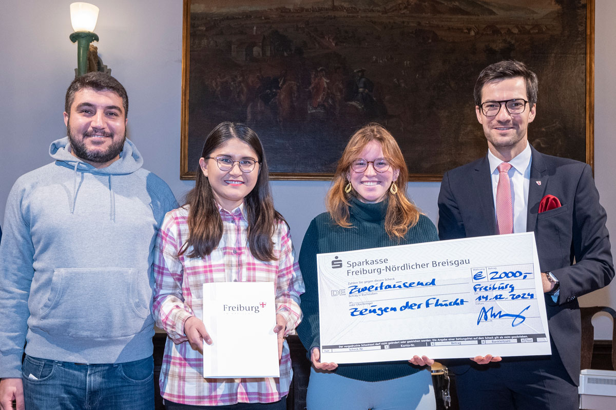 Vertreter*innen von Zeugen der Flucht mit einem Spendencheck