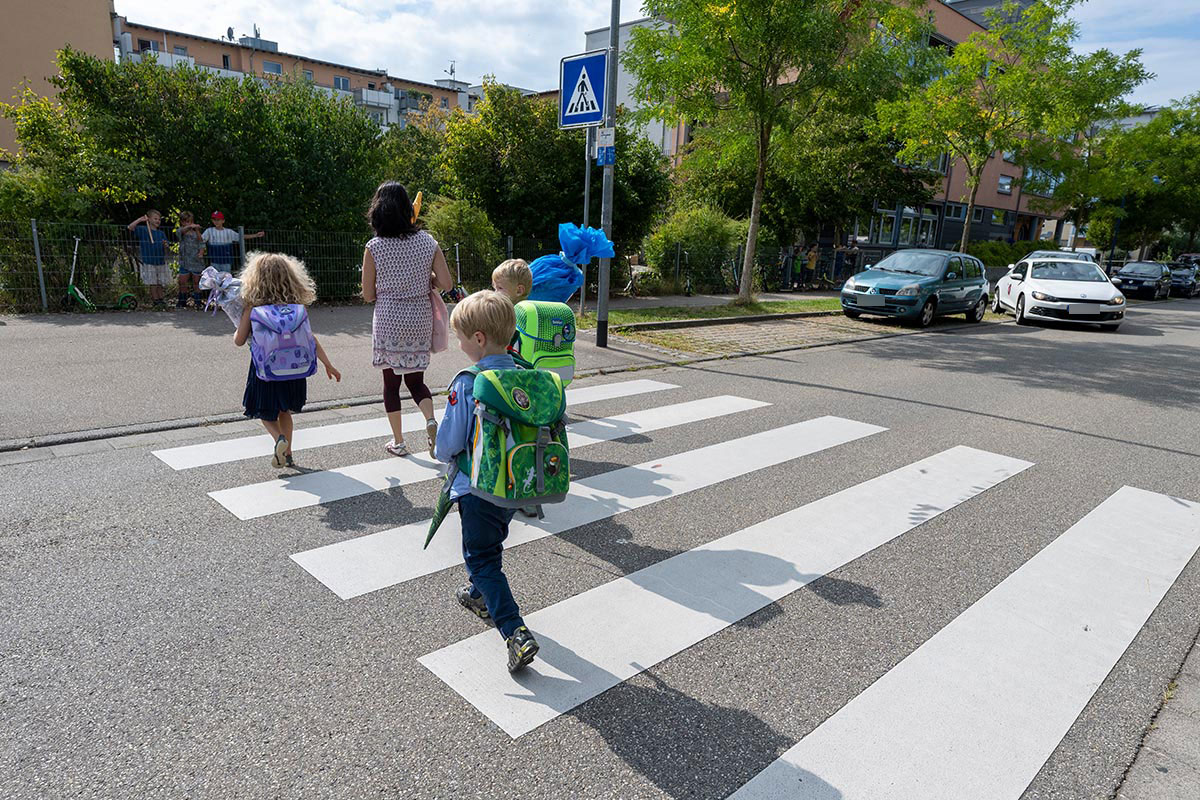 Kinder mit Schultüten auf einem Zebrastreifen