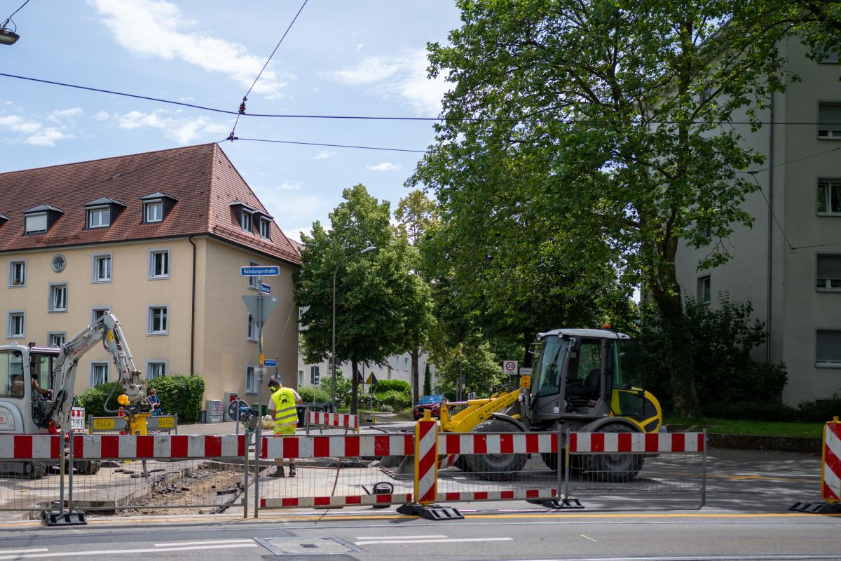Baustelle mit Absperrrungen und Bagger an der Kreuzung Habsburger- / Okenstraße