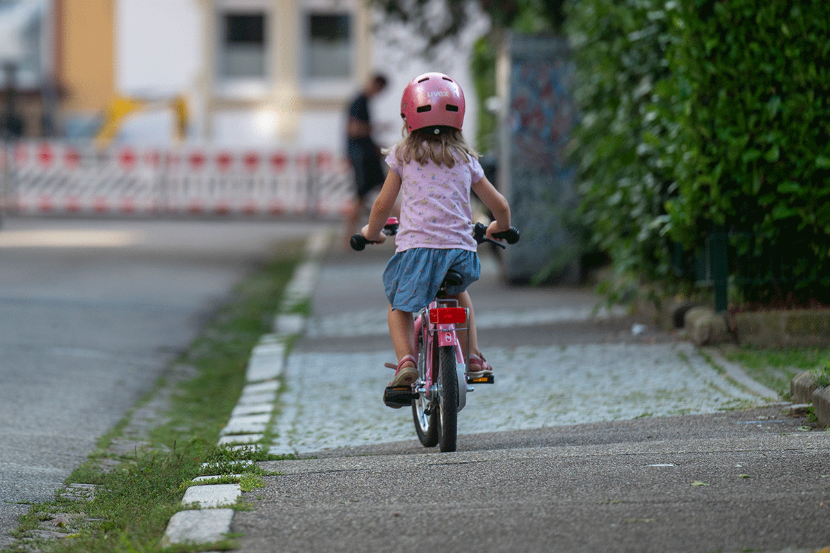 Mädchen auf einem Fahrrad von hinten